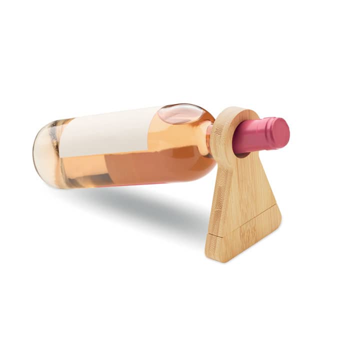 A drink bottle holder made of bamboo, supporting a pink-capped wine bottle filled with rosé.