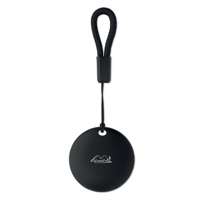 A round black promotional product with a strap, featuring a logo.