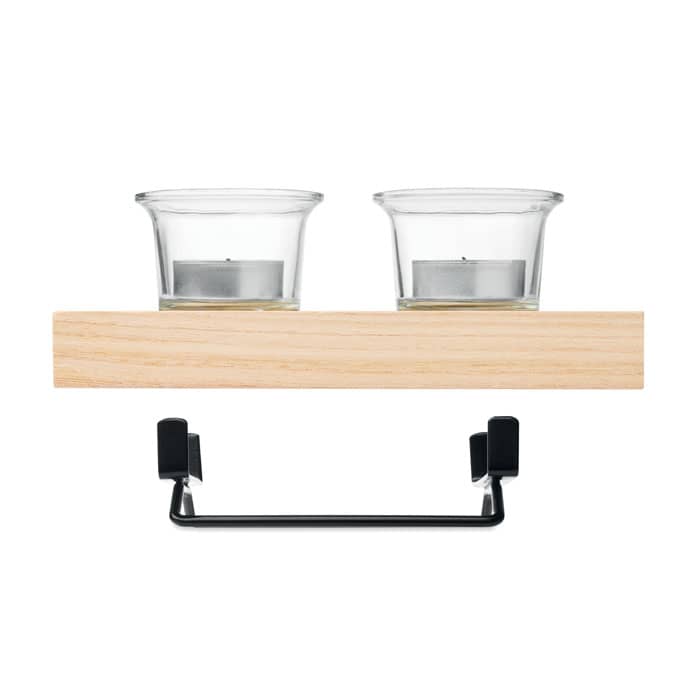 A wooden shelf with two glass candle holders and a black metal hook beneath for hanging items.