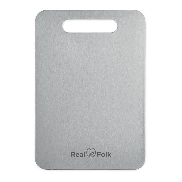 A stainless steel chopping board in silver with a handle and a logo on the bottom.