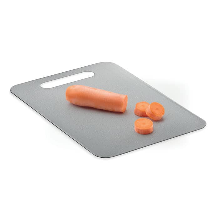 A cutting board with a whole carrot and sliced pieces on it, featuring a handle and a sleek grey surface.