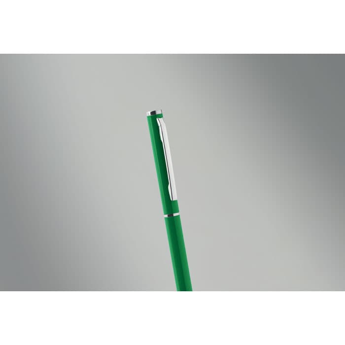A green pen with a silver clip, featuring a sleek design against a grey background.