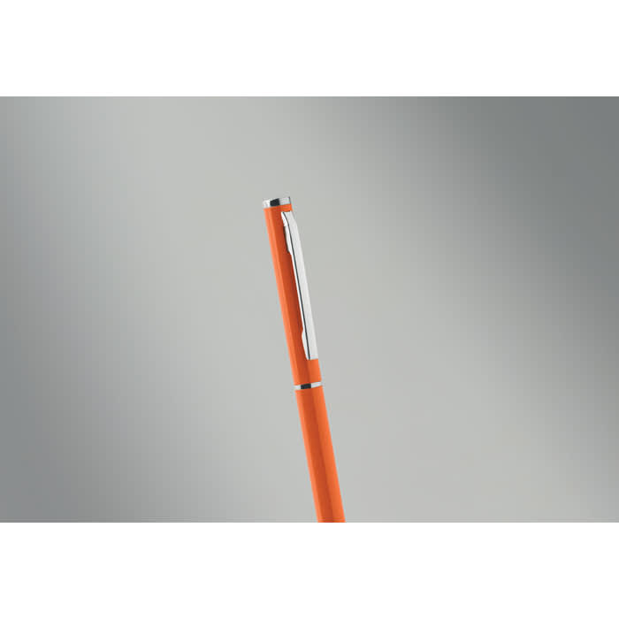 An orange pen with a silver clip against a soft grey background. It has a sleek, modern design.