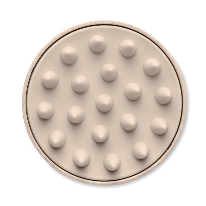 A circular massage tool in a light beige colour featuring multiple raised points for stimulation.