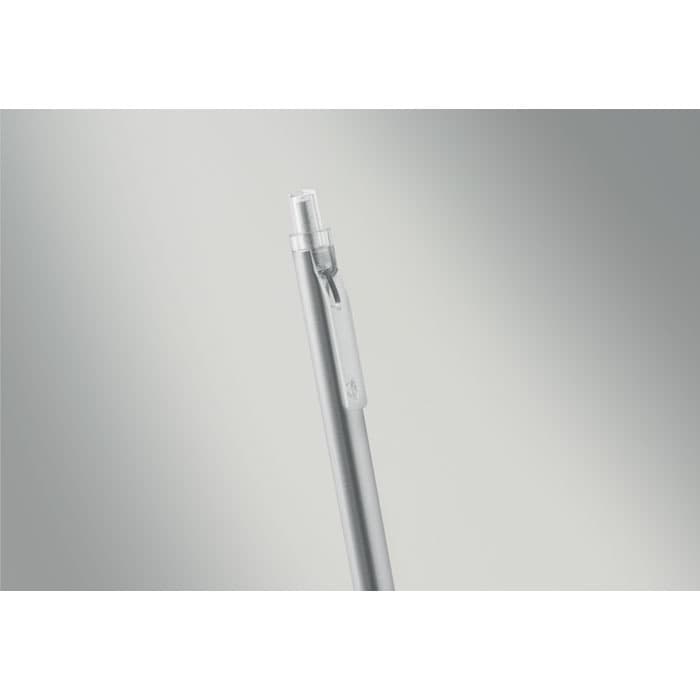 A silver pen with a retractable tip is prominently displayed against a blurred background.