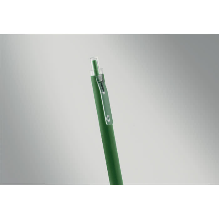 A green pen with a transparent cap and clip, displayed against a grey background.