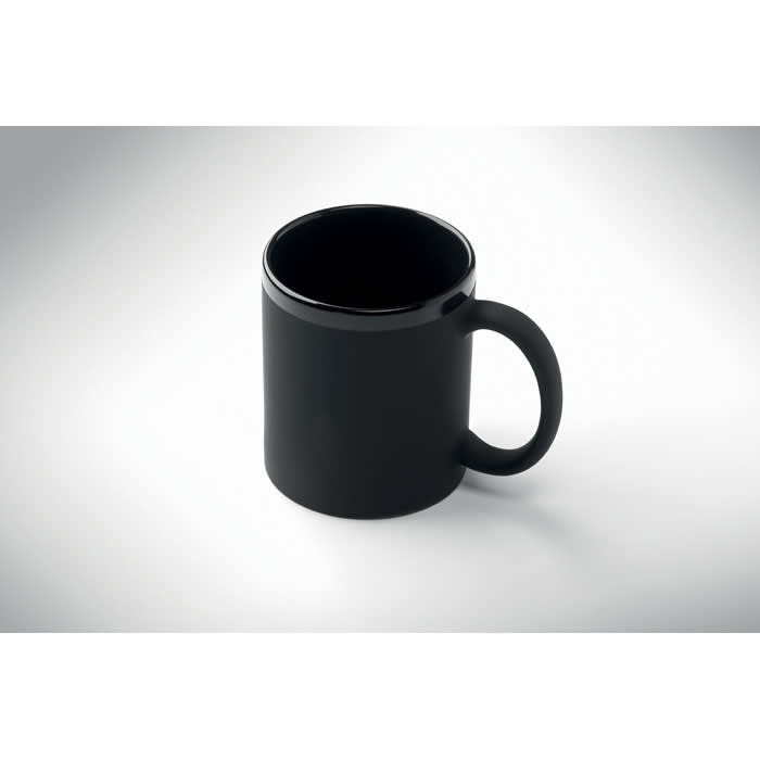 A black drink mug with a round body and a single handle, featuring a shiny finish.