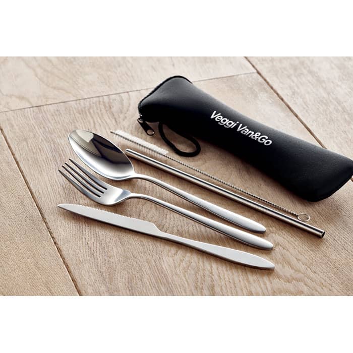 A set of stainless steel cutlery including a spoon, fork, knife, and reusable straw in a black carrying case.