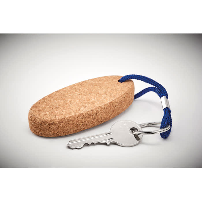 A cork keychain in an oval shape, featuring a blue cord and a metal key attached.