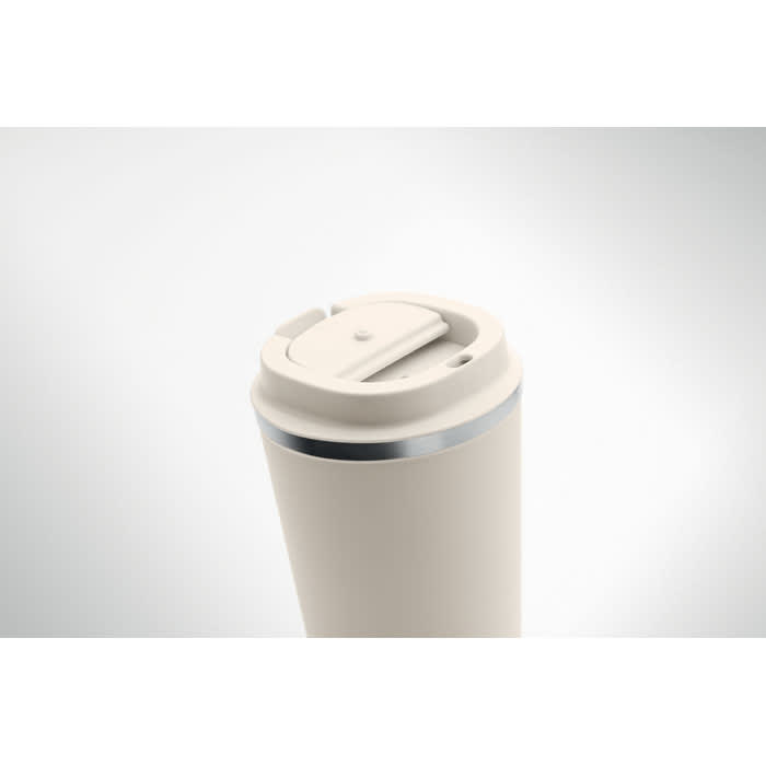 A drink bottle in a cream colour with a silver band and a flip-top lid. It features a logo on the side.