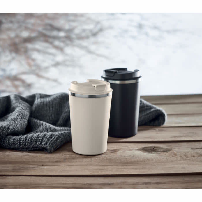 A drink bottle set featuring one cream and one black container, both with lids, resting on a wooden surface.