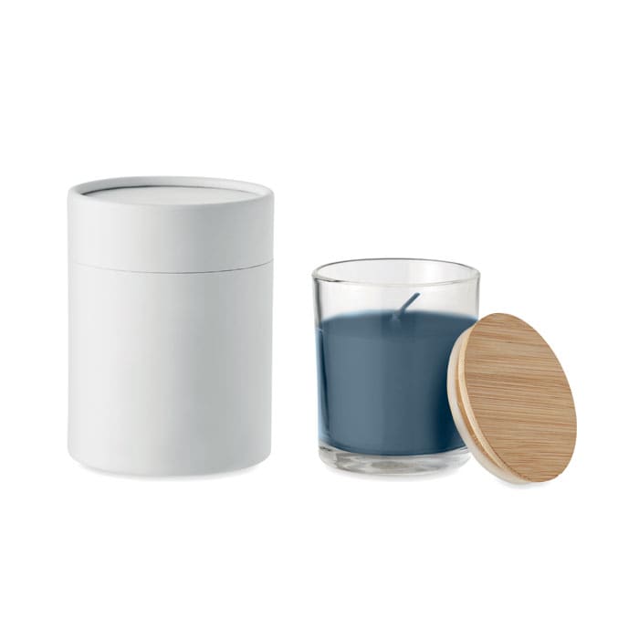 A candle in a glass holder with a bamboo lid, featuring a white container and a blue wax interior. It has a logo.