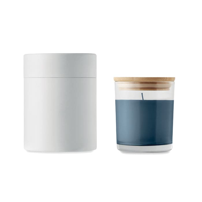 A candle in a glass holder with a wooden lid, featuring a grey exterior and a blue wax interior.