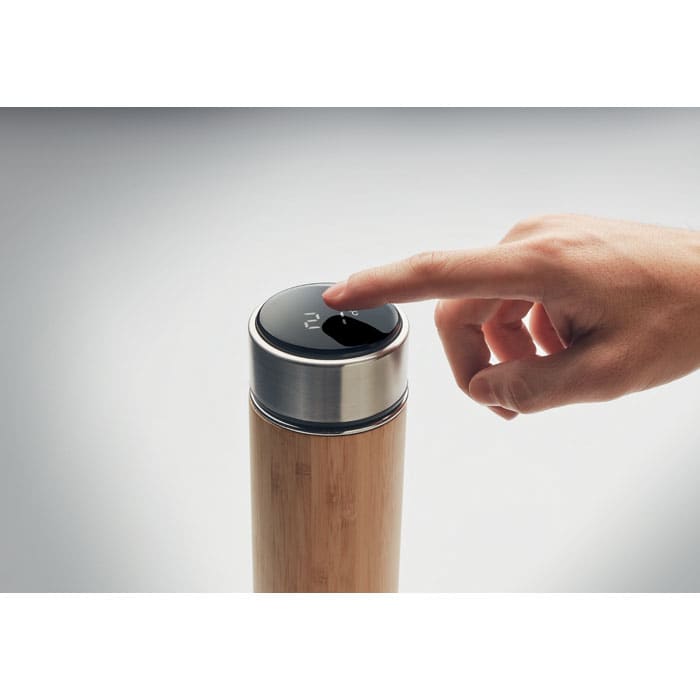 A drink bottle with a bamboo body and a silver metal lid, featuring a touch button on top.