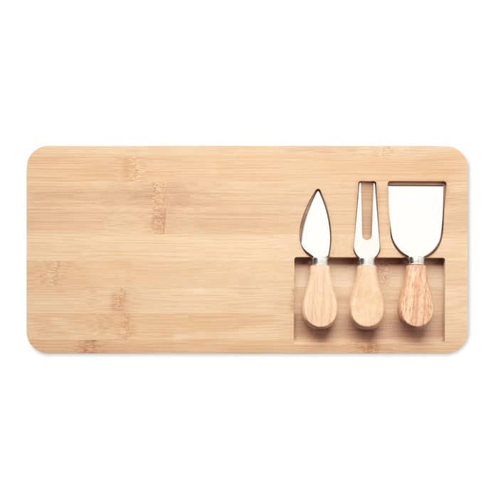 A bamboo cutting board with three wooden-handled cheese knives displayed in cutouts.