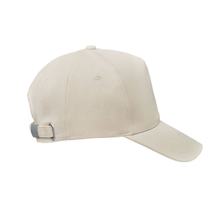 A beige cap with a curved brim and an adjustable strap at the back, featuring a logo on the front.