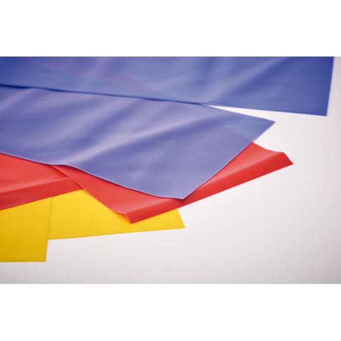 A collection of flat, flexible sheets in blue, red, yellow, and purple, stacked together on a light background.