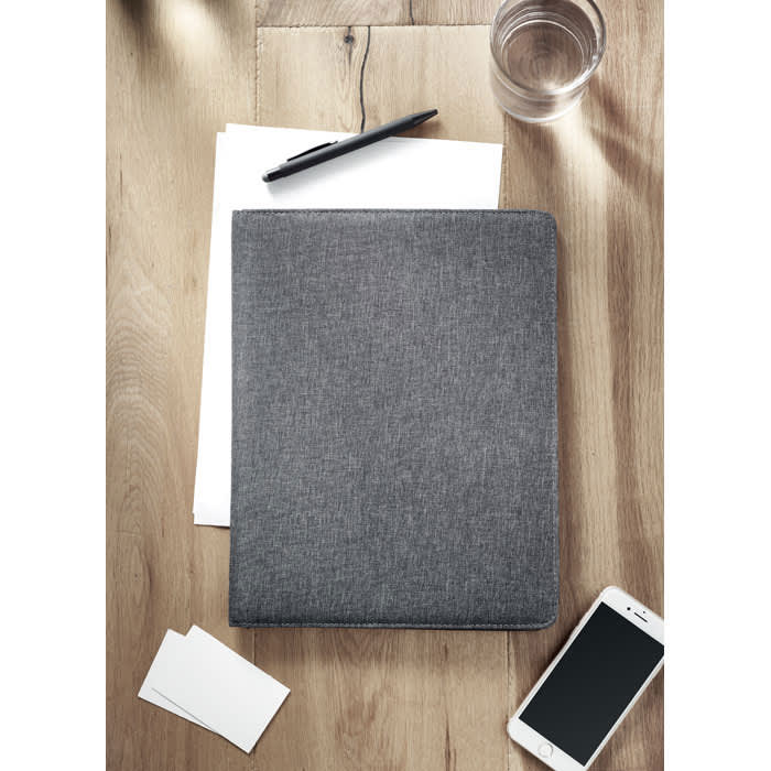 A grey folder rests on a wooden surface near white sheets, a pen, a glass of water, and a smartphone.