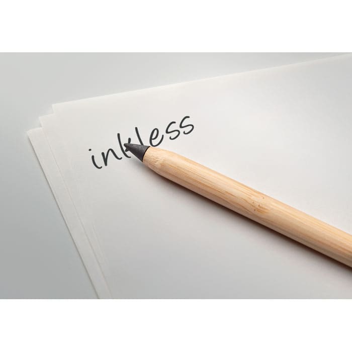 A wooden pencil rests on a blank sheet of paper with the word "inkless" written on it. The background is neutral.
