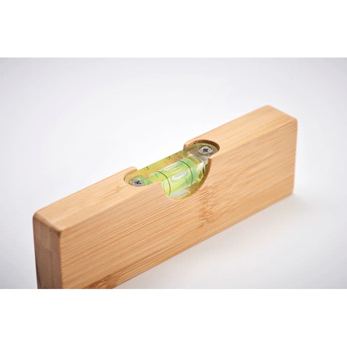 A bamboo spirit level featuring a green bubble vial, showcasing natural wood texture and finish.