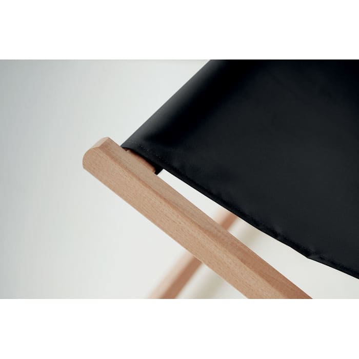 A foldable chair with a black canvas seat and light wooden frame, showcasing sleek design and craftsmanship.