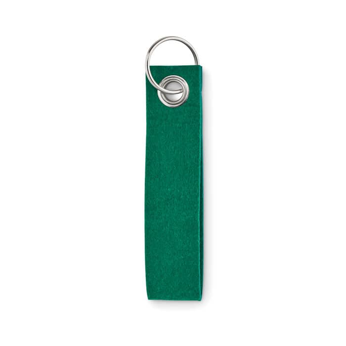 A green fabric tag with a metal ring at one end, designed for attachment or labelling purposes.