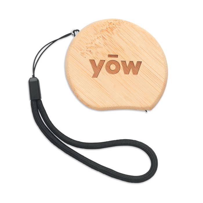 A round bamboo product with a black wrist strap and a logo on the front.