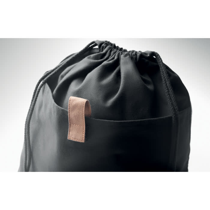 A black drawstring bag with a leather loop and a front pocket. It has a simple and modern design.