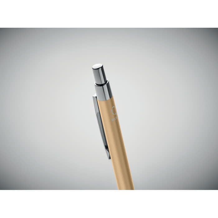 A gold pen with a chrome clip and button, featuring sleek lines and a minimalist design.