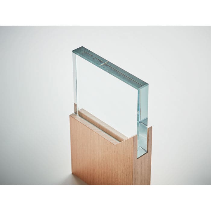 A drink bottle featuring a clear transparent body with a wooden base, showcasing a modern and minimalist design.
