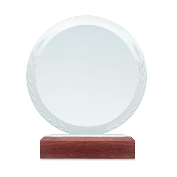 A circular clear glass award with a laurel leaf design, mounted on a wooden base.