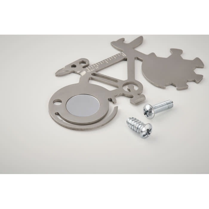 A metallic multitool with a circular mirror and two screws, featuring a bike design.