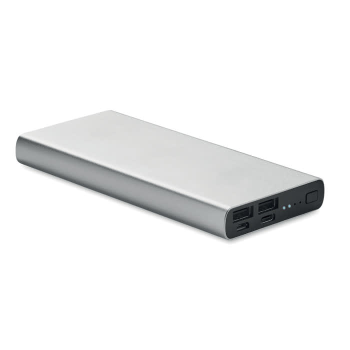 A power bank with a sleek silver design, featuring multiple USB ports and a small indicator light.