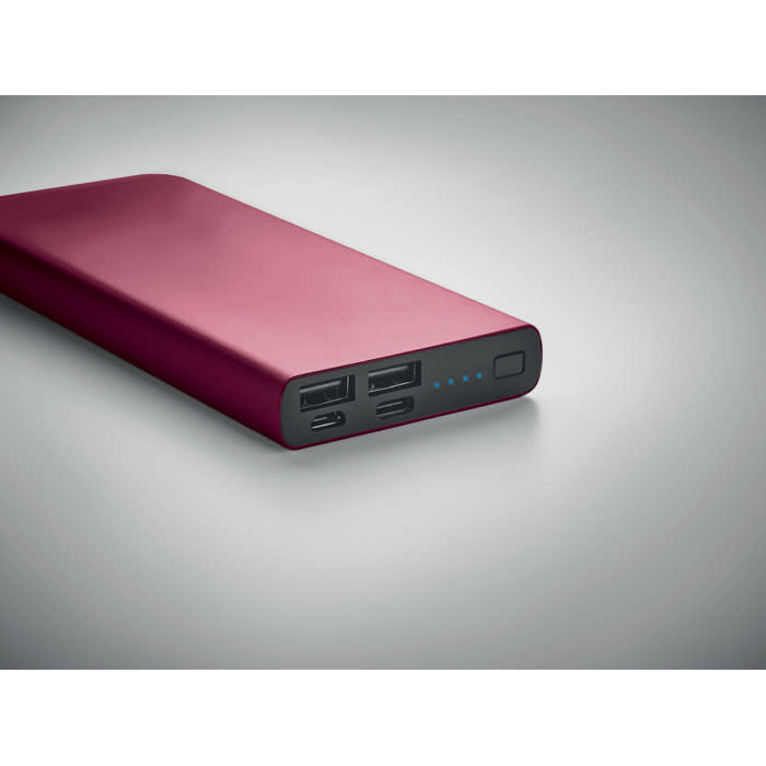 A portable power bank in a deep burgundy colour with multiple USB ports and an LED battery indicator.