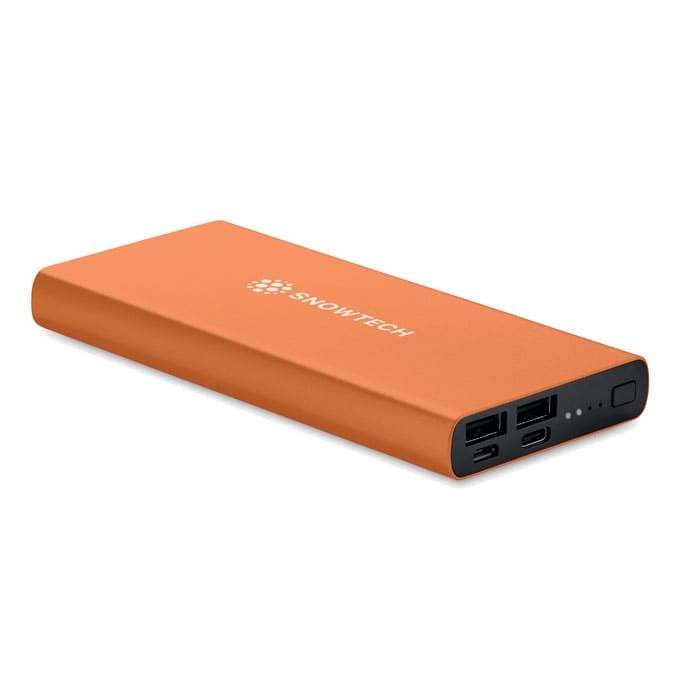 An orange power bank with multiple USB ports and a logo. It has a sleek, rectangular design.
