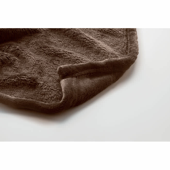A soft, brown throw blanket with a textured finish, featuring a neatly folded edge.