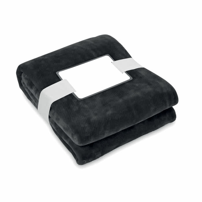 A folded soft black blanket, neatly packaged with a white band around it and a blank label.