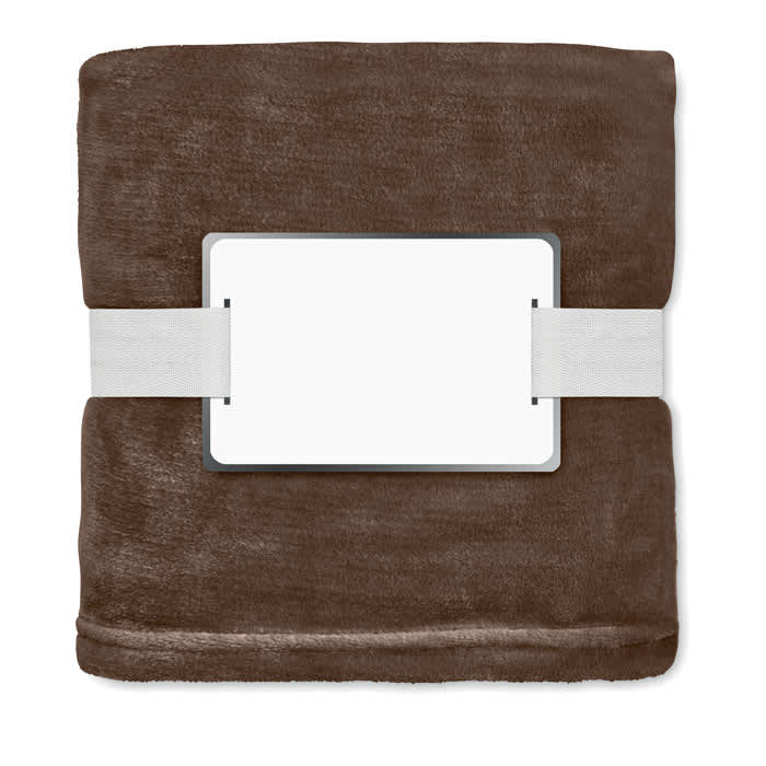 A brown blanket neatly folded and secured with a white band, featuring a blank label in the centre.