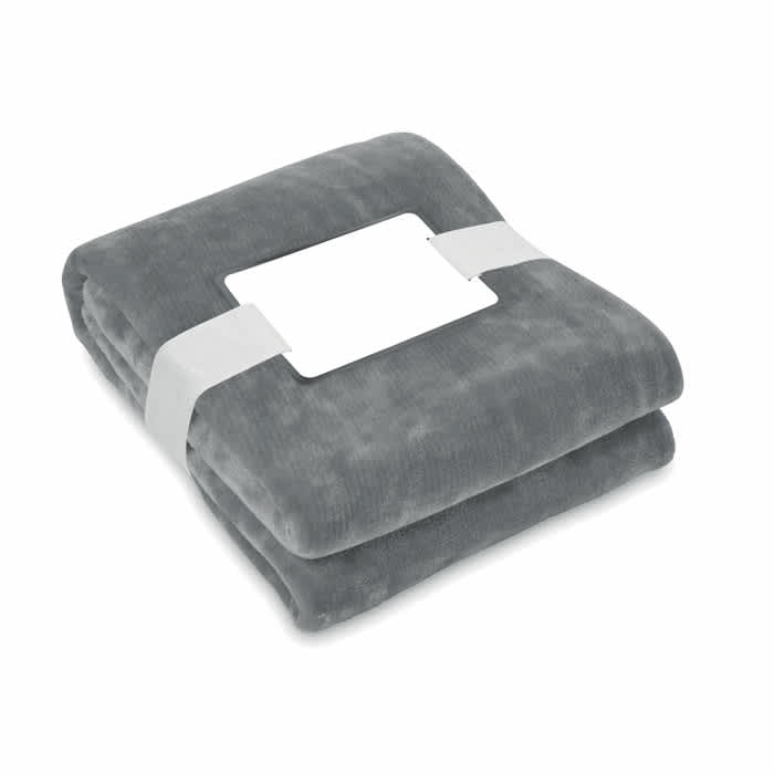 A folded grey blanket secured with a white band, featuring a blank label in the centre.
