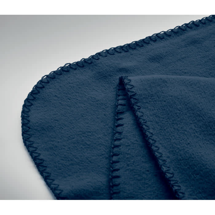 A navy blue blanket with a stitched edge, folded to display its texture and design.