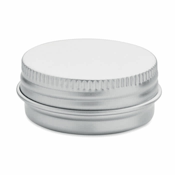 A silver metal balm container with a screw-on lid and a ribbed edge. It has an unbranded design.