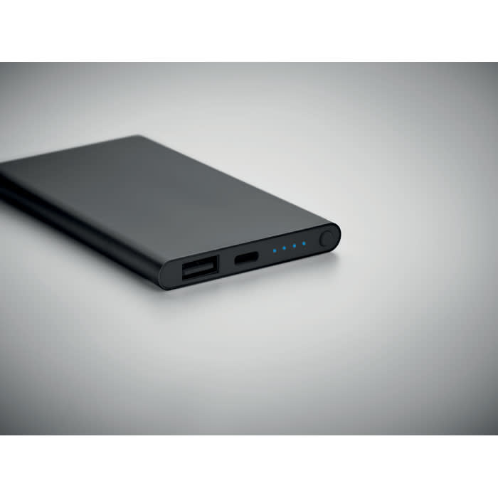 A power bank in sleek black, featuring USB ports and LED indicators on one side.