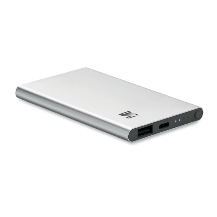 A power bank in silver with a sleek design, featuring multiple ports and a small indicator light.