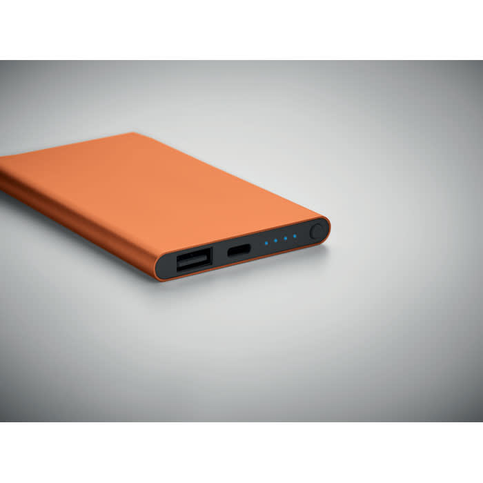 An orange portable charger with USB and USB-C ports, featuring indicator lights on one side.