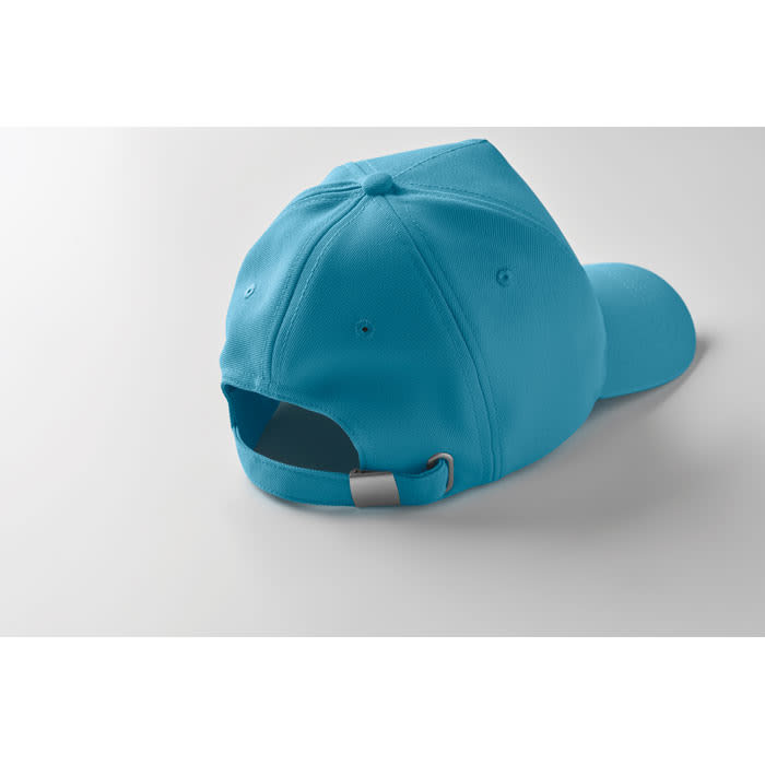 A cap in bright blue with an adjustable strap and a curved peak, showcasing a clean design and vibrant colour.