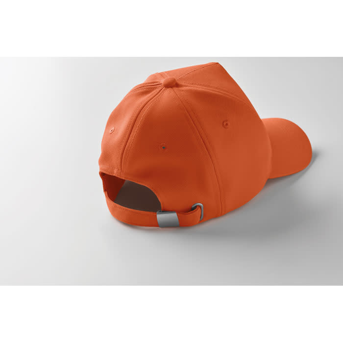 An orange cap featuring a curved brim and an adjustable metal strap at the back.