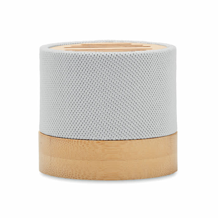 A round speaker featuring a light grey mesh top and a bamboo base. It has a smooth, modern design.