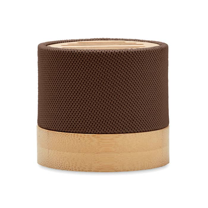 A brown, cylindrical speaker with a textured surface and a bamboo base, featuring a logo on the side.