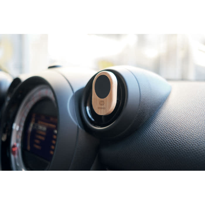 A car air vent mount in a sleek design, featuring a round holder with a black and silver finish, and a logo.