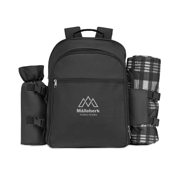 A black backpack with multiple compartments, featuring a branded logo and attached picnic blanket and bottle holder.